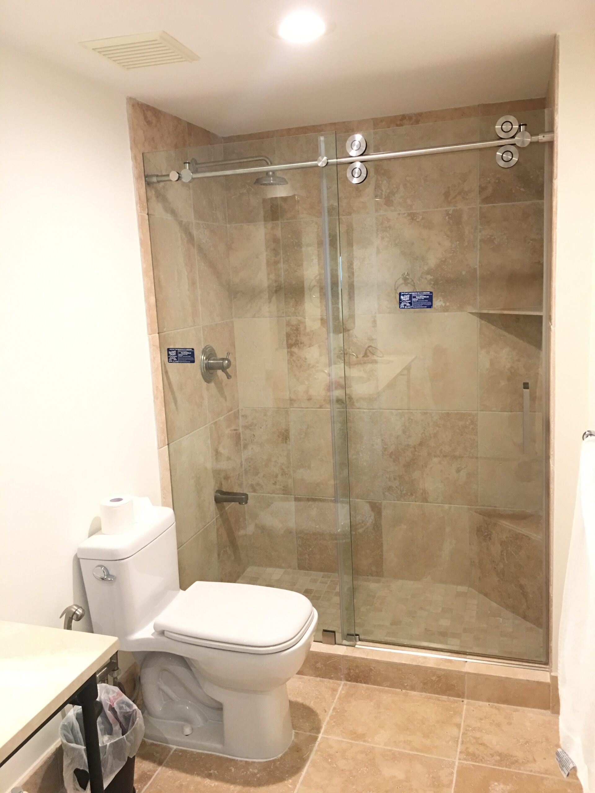 Frameless sliding shower door installed in Miami bathroom