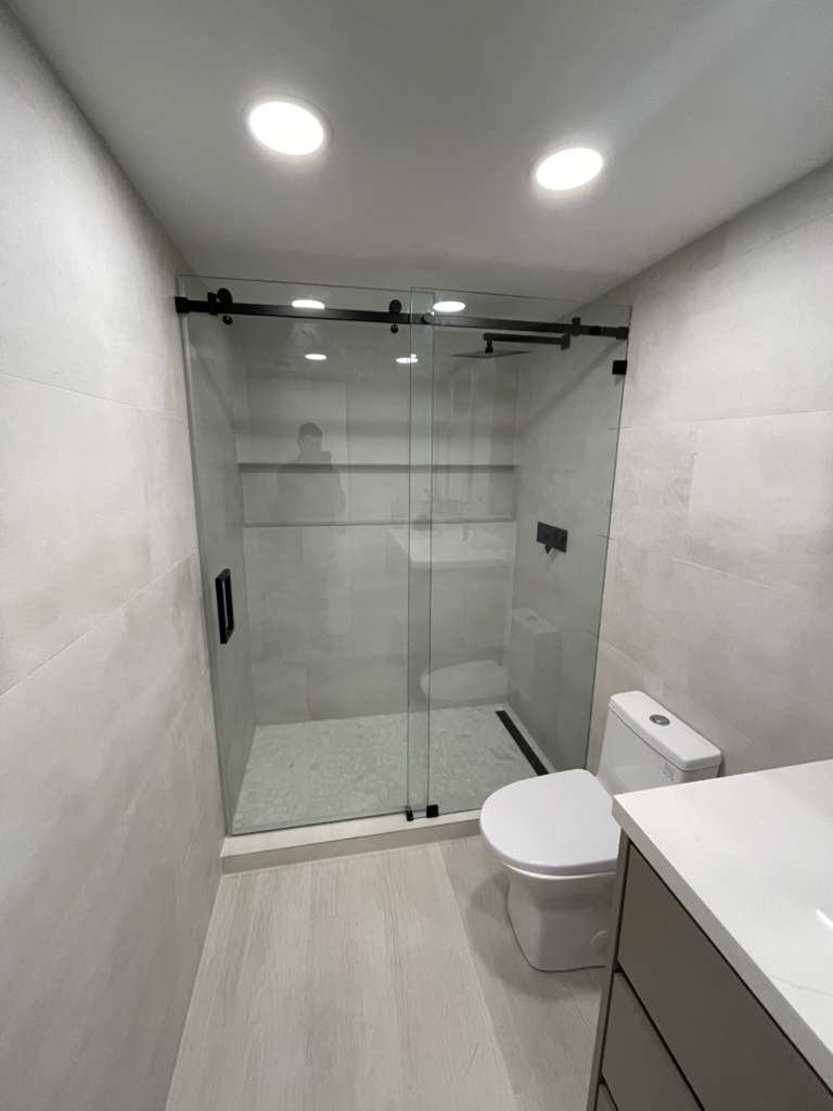 Frameless sliding shower door black hardware Miami