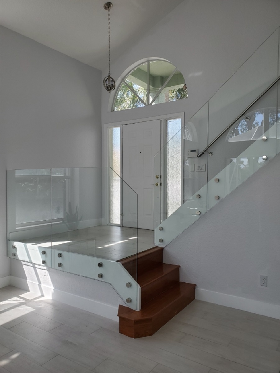 Frameless glass railing installation Miami staircase chrome hardware