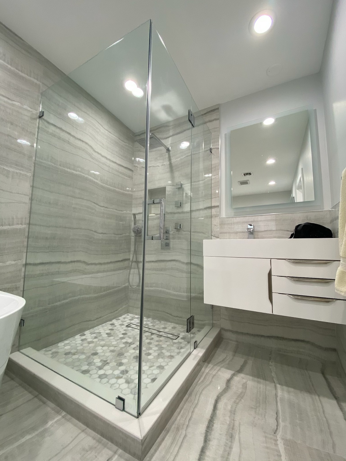L-shape frameless shower enclosure wide angle view Miami